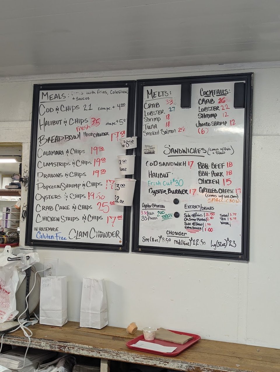 Menu board with fried fish and chowder.